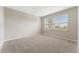 Simple bedroom with neutral walls and carpet flooring at 12410 Osorio Ct # 103, Sarasota, FL 34238