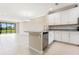 Modern kitchen with white cabinets, granite counters, and stainless steel appliances at 12410 Osorio Ct # 103, Sarasota, FL 34238