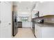 Open concept kitchen boasting stainless steel appliances and granite counters at 12410 Osorio Ct # 103, Sarasota, FL 34238