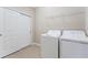 Laundry room with washer, dryer, and additional shelving at 12410 Osorio Ct # 103, Sarasota, FL 34238