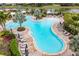 Freeform pool with a swim-up bar and plenty of lounge space at 12410 Osorio Ct # 103, Sarasota, FL 34238