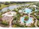 Community pool with water features, a playground and lounge area at 12410 Osorio Ct # 103, Sarasota, FL 34238