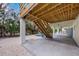 Unfinished basement with concrete floor and stairs at 127 Crescent Dr, Anna Maria, FL 34216