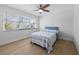 Cozy bedroom with light wood floors and a blue upholstered headboard at 127 Crescent Dr, Anna Maria, FL 34216