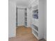 Walk-in closet with ample shelving and drawers at 127 Crescent Dr, Anna Maria, FL 34216