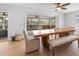 Dining room with sliding doors to balcony and wood dining table at 127 Crescent Dr, Anna Maria, FL 34216