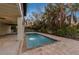 Inviting swimming pool surrounded by tropical plants at 127 Crescent Dr, Anna Maria, FL 34216