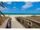 Boardwalk to beach access with sandy shore and ocean view at 13153 Steinhatchee Loop, Venice, FL 34293