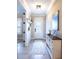 Hallway with white shiplap, light fixtures, and a console table at 13153 Steinhatchee Loop, Venice, FL 34293