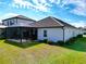 White home exterior with dark brown roof and screened lanai at 13153 Steinhatchee Loop, Venice, FL 34293