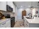 White kitchen with stainless steel appliances and quartz countertops at 13153 Steinhatchee Loop, Venice, FL 34293