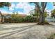 Large gravel parking area and mature trees at 1320 Cocoanut Ave, Sarasota, FL 34236