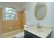 Bathroom with beige tile, vanity, and oval mirror at 1320 Cocoanut Ave, Sarasota, FL 34236