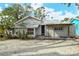 House exterior with covered patio and gravel driveway at 1320 Cocoanut Ave, Sarasota, FL 34236