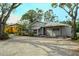 House exterior with gravel driveway and mature trees at 1320 Cocoanut Ave, Sarasota, FL 34236