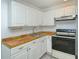 Bright kitchen features white cabinets, tile countertops, and a stove at 1320 Cocoanut Ave, Sarasota, FL 34236