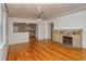 Living room with hardwood floors, fireplace, and kitchen view at 1320 Cocoanut Ave, Sarasota, FL 34236