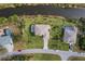 Aerial view of two canal-front homes with pools and green lawns at 1572 Nimbus Dr, North Port, FL 34287