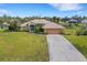 Single-story house, large backyard, and long driveway at 1572 Nimbus Dr, North Port, FL 34287