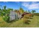 Landscaped backyard with tropical plants and canal access at 1572 Nimbus Dr, North Port, FL 34287