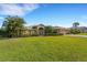 One-story home with a large yard, palm trees, and attached garage at 1572 Nimbus Dr, North Port, FL 34287