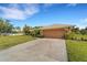 One-story home with attached garage and landscaped yard at 1572 Nimbus Dr, North Port, FL 34287