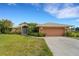 Single-story house with attached garage and well-maintained lawn at 1572 Nimbus Dr, North Port, FL 34287