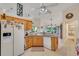 Bright kitchen with wood cabinets, granite countertops, and stainless steel appliances at 1572 Nimbus Dr, North Port, FL 34287