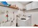 Bright laundry room with washer, dryer, and ample shelving at 1572 Nimbus Dr, North Port, FL 34287