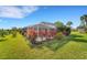 Inviting screened pool area with lush tropical landscaping at 1572 Nimbus Dr, North Port, FL 34287