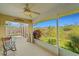 Relaxing screened pool area with rocking chair and tranquil water views at 1572 Nimbus Dr, North Port, FL 34287