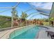 Refreshing kidney-shaped pool with screened enclosure at 1572 Nimbus Dr, North Port, FL 34287