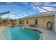 Inviting kidney-shaped pool with screened enclosure at 1572 Nimbus Dr, North Port, FL 34287