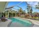 Inviting kidney-shaped swimming pool with screened enclosure at 1572 Nimbus Dr, North Port, FL 34287