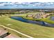 Aerial view showcasing homes, golf course, and water features at 18114 Gawthrop Dr # 404, Bradenton, FL 34211