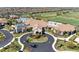 Resort-style clubhouse with circular driveway and landscaping at 18114 Gawthrop Dr # 404, Bradenton, FL 34211