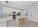 Modern kitchen with white cabinets and an island at 18114 Gawthrop Dr # 404, Bradenton, FL 34211