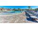 Expansive resort pool with numerous lounge chairs and umbrellas at 18114 Gawthrop Dr # 404, Bradenton, FL 34211