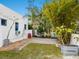 Small, paved backyard with tropical landscaping and a Countyline metal planter at 202 27Th W St, Bradenton, FL 34205