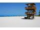 Lifeguard stand on a sunny beach with people enjoying the day at 202 27Th W St, Bradenton, FL 34205