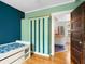 Bedroom with wood floors,teal and mint walls at 202 27Th W St, Bradenton, FL 34205