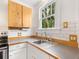 White kitchen with wood countertops and subway tile backsplash at 202 27Th W St, Bradenton, FL 34205