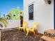 Small patio area with two yellow chairs and colorful mosaic tile steps at 202 27Th W St, Bradenton, FL 34205