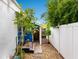 Side yard with a blue-painted exterior, tile steps, and lush greenery at 202 27Th W St, Bradenton, FL 34205