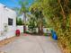 Small side yard with gravel ground cover and mature tropical plants at 202 27Th W St, Bradenton, FL 34205