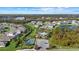 Aerial view of community with pool, tennis court, and playground at 2028 Woodleaf Hammock Ct, Bradenton, FL 34211