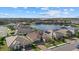 Aerial view of community with lake and homes at 2028 Woodleaf Hammock Ct, Bradenton, FL 34211