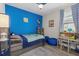 Bright bedroom with blue walls, comfortable bed, and workspace at 2028 Woodleaf Hammock Ct, Bradenton, FL 34211