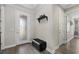 Bright and airy entryway with a bench and storage shelf at 2028 Woodleaf Hammock Ct, Bradenton, FL 34211