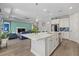 Modern kitchen with island, stainless steel appliances, and white cabinets at 2028 Woodleaf Hammock Ct, Bradenton, FL 34211